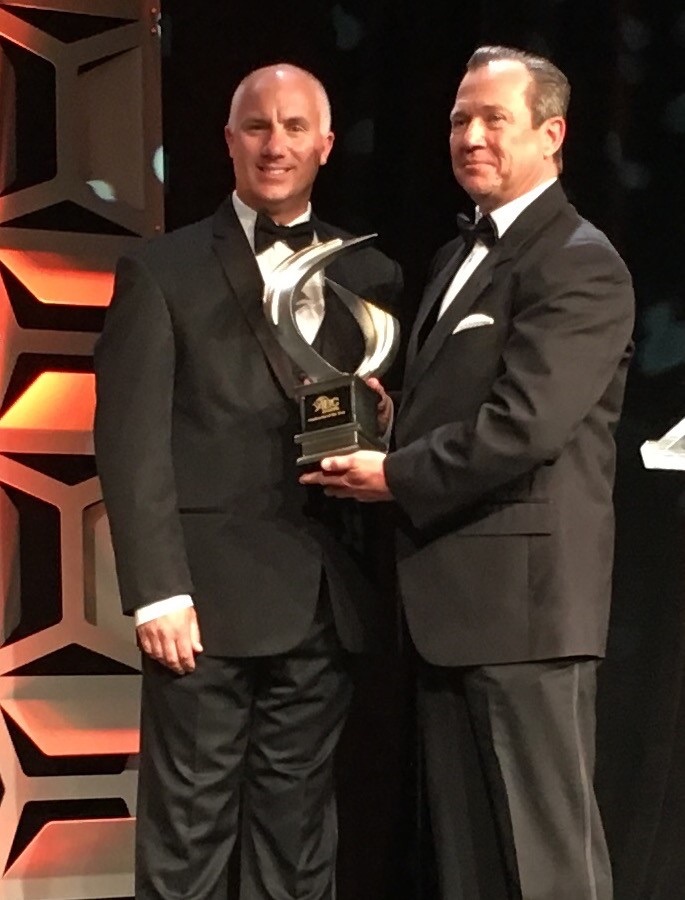 ABC national chairman David Chapin presents the Contractor of the Year Award to Art Odom, president David Allen Company